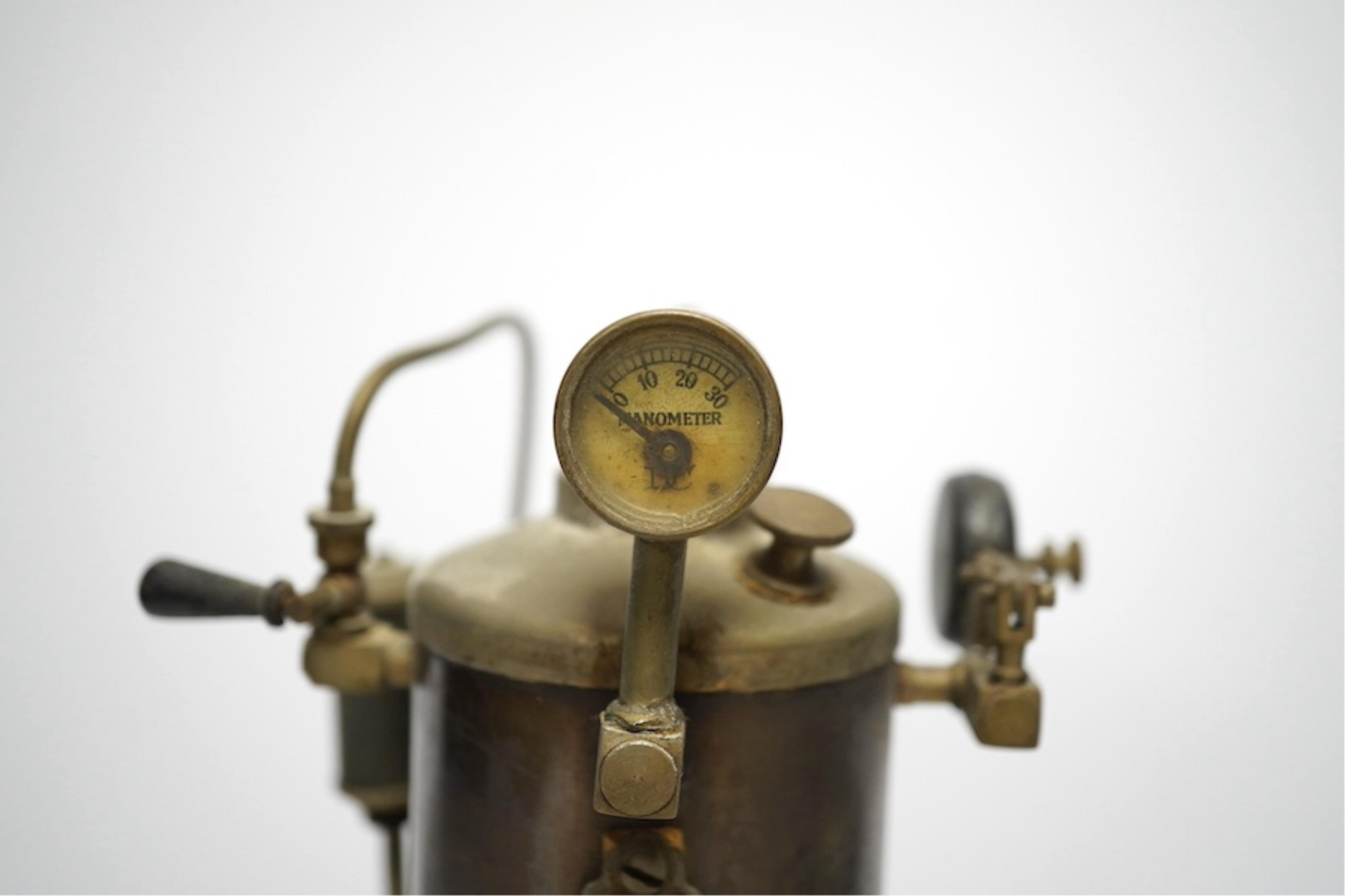 A Doll and Co. tinplate vertical boiler live steam single cylinder stationary engine, 26cm high. Condition - fair